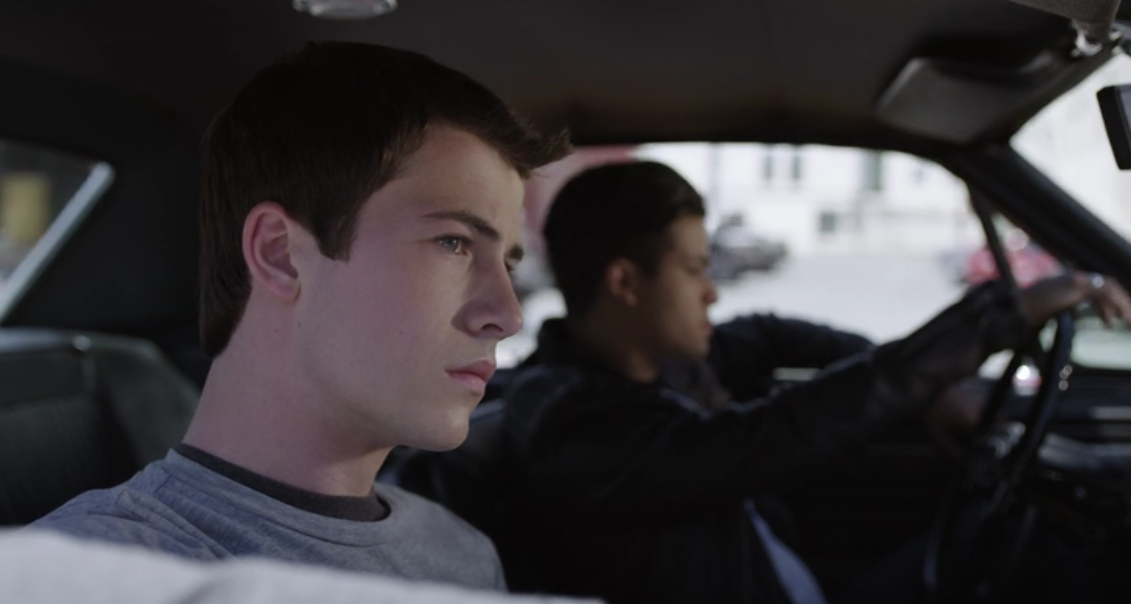 13-Reasons-Why-Still-3-Clay-Dylan-Minette-Closer-up-as-Tony-Christian-Navarro-Drives-the-Red-Car-Down-the-Street.png